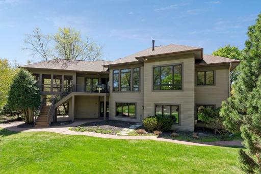 Exterior of home showcasing the covered deck with built-in grill, stamped concrete patio and wiring for a hot tub.