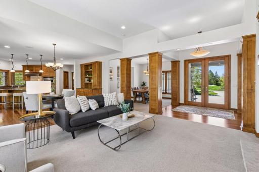 The formal dining area is beautifully flanked by custom wood pillars that add warmth and architectural detail.