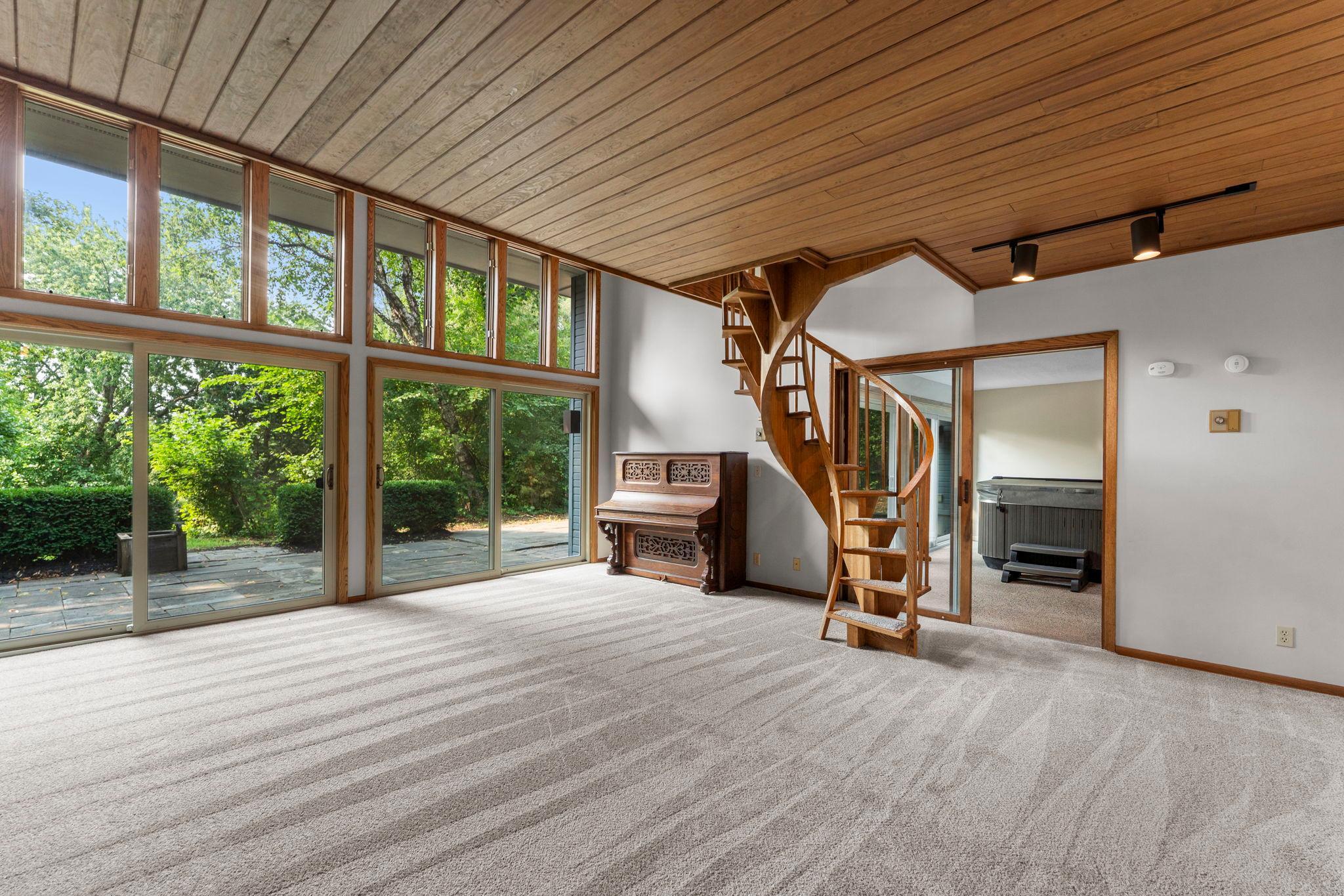 The spiral staircase enhances character just outside the jacuzzi