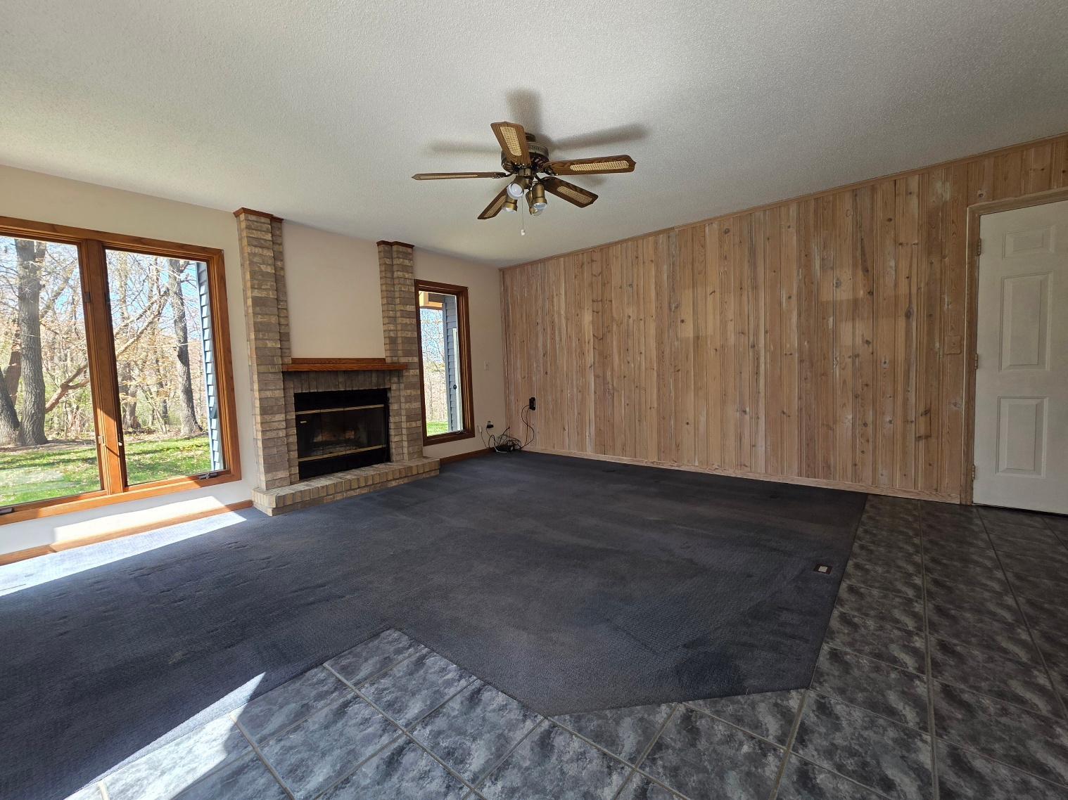 Den with woodburning fireplace