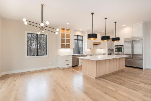 Gourmet kitchen with designer light fixtures