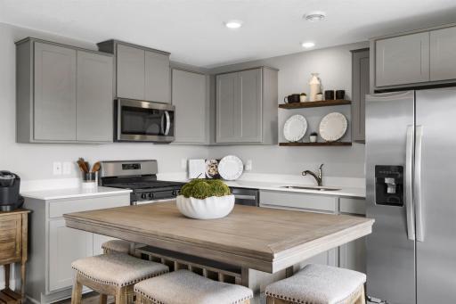 Thoughtfully designed kitchen with stainless appliance package including gas range, dishwasher and vented micro-hood. (Model photo, colors may vary)