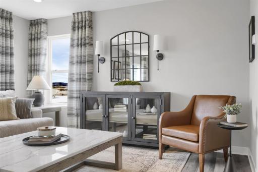 The main living space is open and full of light with an abundance of windows. (Model photo, colors may vary)