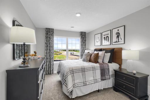 Beautiful primary bedroom upstairs with private en suite bathroom and walk-in closet. (Model photo, colors may vary)