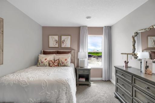 Each of the three bedrooms is unique and offers beautiful views from the large windows. (Model photo, colors may vary)