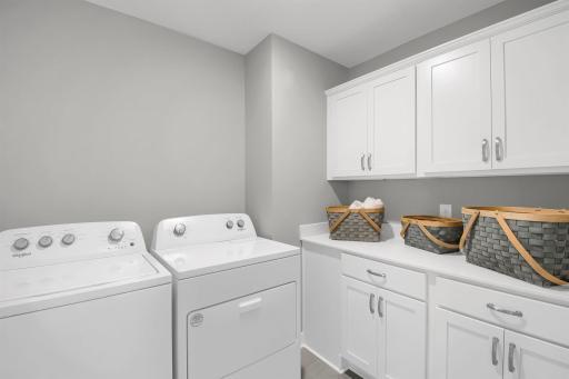 Bedroom level laundry with optional cabinets. Model photos. Options and colors will vary.