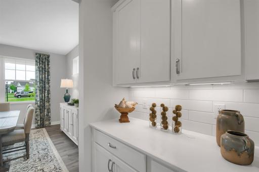 Butler's pantry conveniently located between the kitchen and dining room. Imagine entertaining here! Model photos. Options and colors will vary.