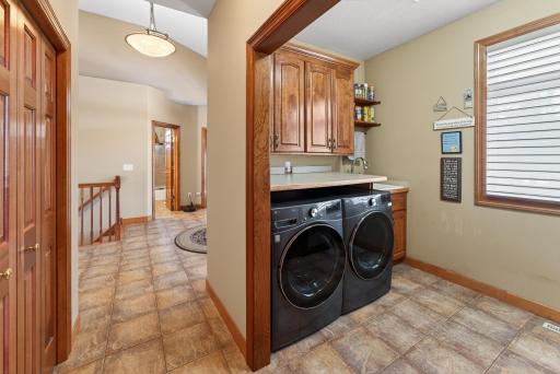 main floor laundry coat closet off foyer tile floors