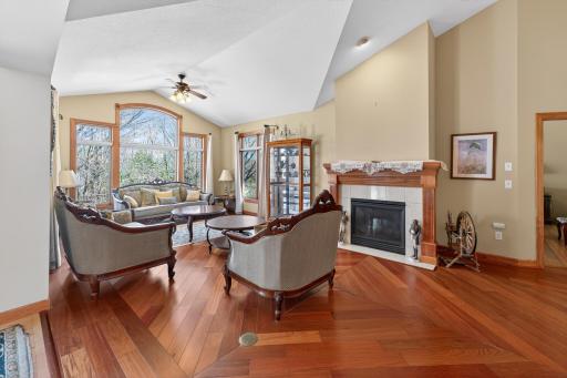 Living room with large windows overlook back yard, gas fireplace