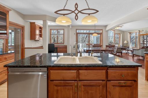 Kitchen view to office nook and informal dining area - granite counter tops