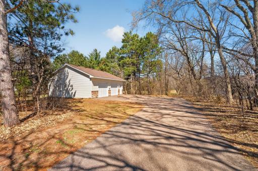 own drive to the detached garage off S Coon Creek Dr. Oversized 2 car garage with 3 garage doors plus service door - with RV Hook up - WIFI in garage, Security System installed and Air Compressor included in sale.