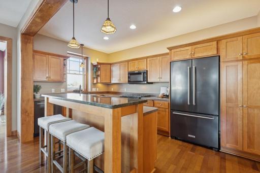 Great kitchen with stainless steel appliances, island, and breakfast bar.