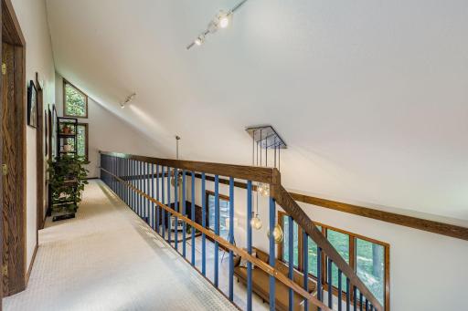 Vaulted ceilings from the second level offer views of the living room.