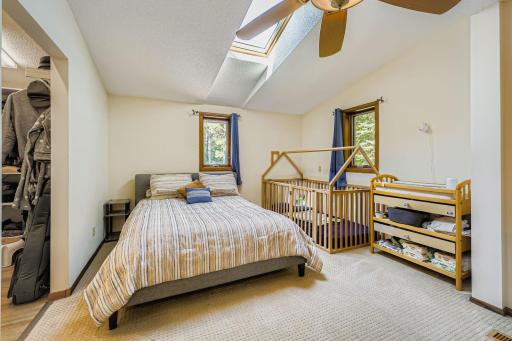 Expansive main level primary bedroom with a skylight
