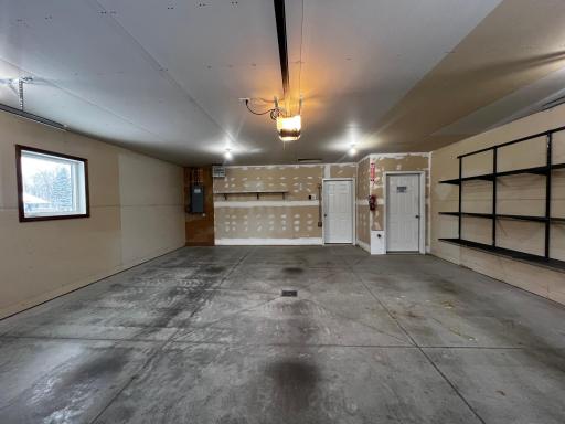 2 Car Insulated & Heated Garage with Floor Drain, Storage and Utility Room.