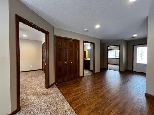 Hallway view of Primary Bedroom, Hall Closet, Bathroom, Second Bedroom and Front Door.