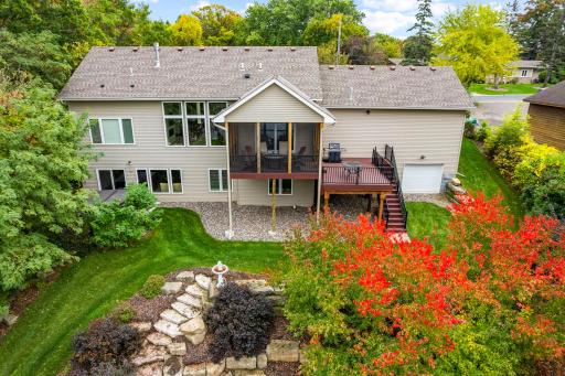 Enjoy sweeping views from the vaulted screened porch or the maintenance-free adjacent deck, complete with stairs leading down to the yard.