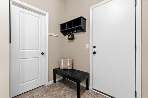 The service door from the garage opens into the mudroom, complete with a walk-in closet, giving you plenty of space to get organized in one of the most important yet underrated areas for day-to-day living.