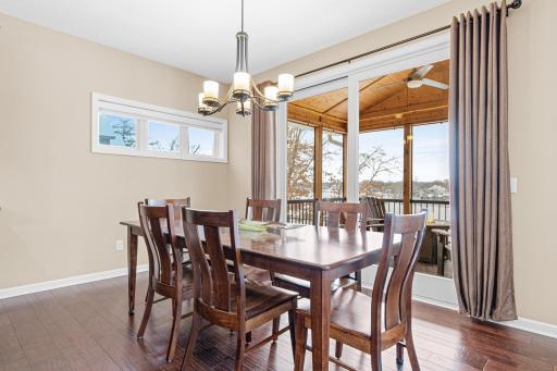 The open-concept main-level living and dining area features sliding doors to the screened porch, creating a smooth flow to the outdoor living space.
