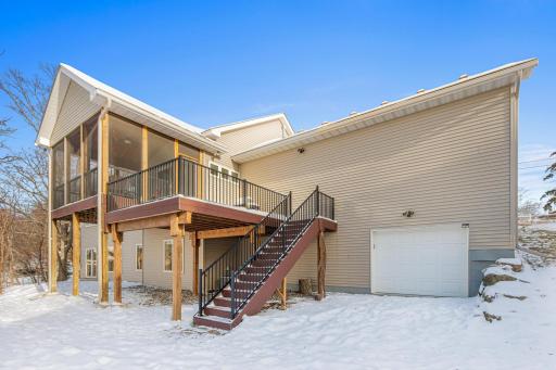 The garage door makes storing lake toys easily accessible, and stairs from the deck provide convenient access to the yard.
