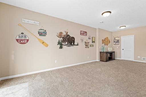 Behind the credenza, plumbing is set up for a future wet bar waiting for your personal touch. With plenty of space, you can design a roomy dream bar/kitchenette. The door behind is finished walk in storage storage & could be used in the plan.