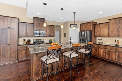 A great kitchen layout for entertaining includes a gas stove, a walk-in pantry, and plenty of cabinetry and counter space.