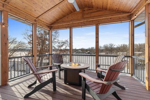 Sliding doors from the main level open to a vaulted screened porch, where you can take in sweeping daytime and sunset views while enjoying the beauty of nature and peaceful surroundings.