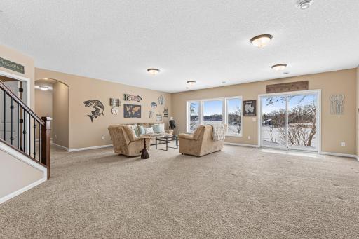 The walkout lower-level family room is roomy enough to fit a game table, pool table, or dinette.