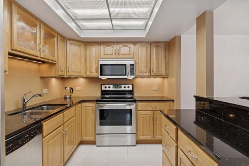 The kitchen boasts stainless appliances, granite counters, abundant storage and under-cabinet lighting.