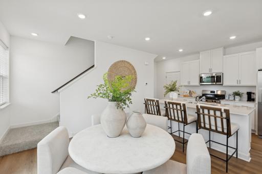 (Photo is of a model home, finishes will vary) Natural light streams in from glass sliders onto the dining area, setting the scene for daily meals with family and friends.