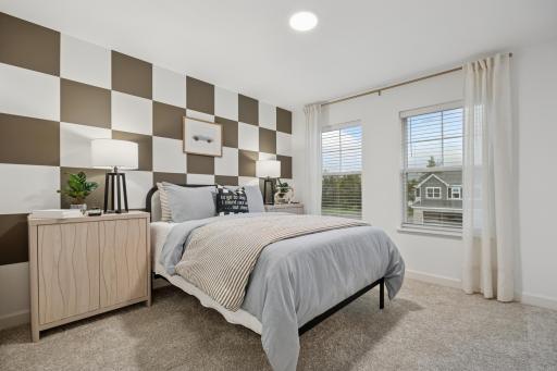 (Photo is of a model home, finishes will vary) Situated down the hallway from the owner’s suite are two secondary bedrooms. Both include a practical closet space and plush wall-to-wall carpeting.