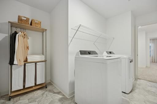 (Photo is of a model home, finishes will vary) This spacious laundry room is located on the same level as the bedrooms in a thoughtful design to get weekly chores done in a snap.