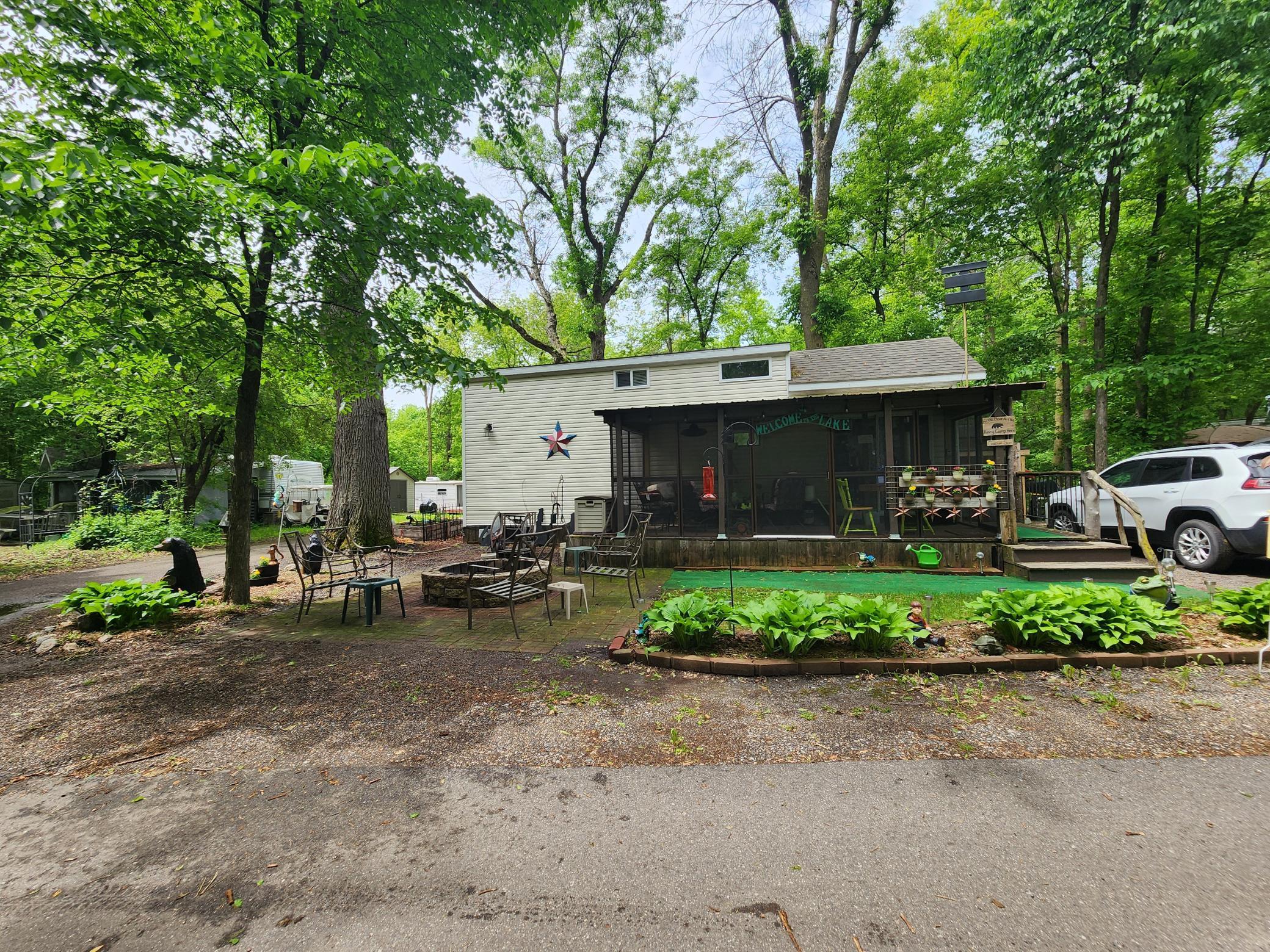 Unit 428 at Cokato Lake RV Resort includes 2017 Heritage Park Model with loft, screen porch, large yard (much of it back yard for playing cornhole, etc.) shed and lots more!