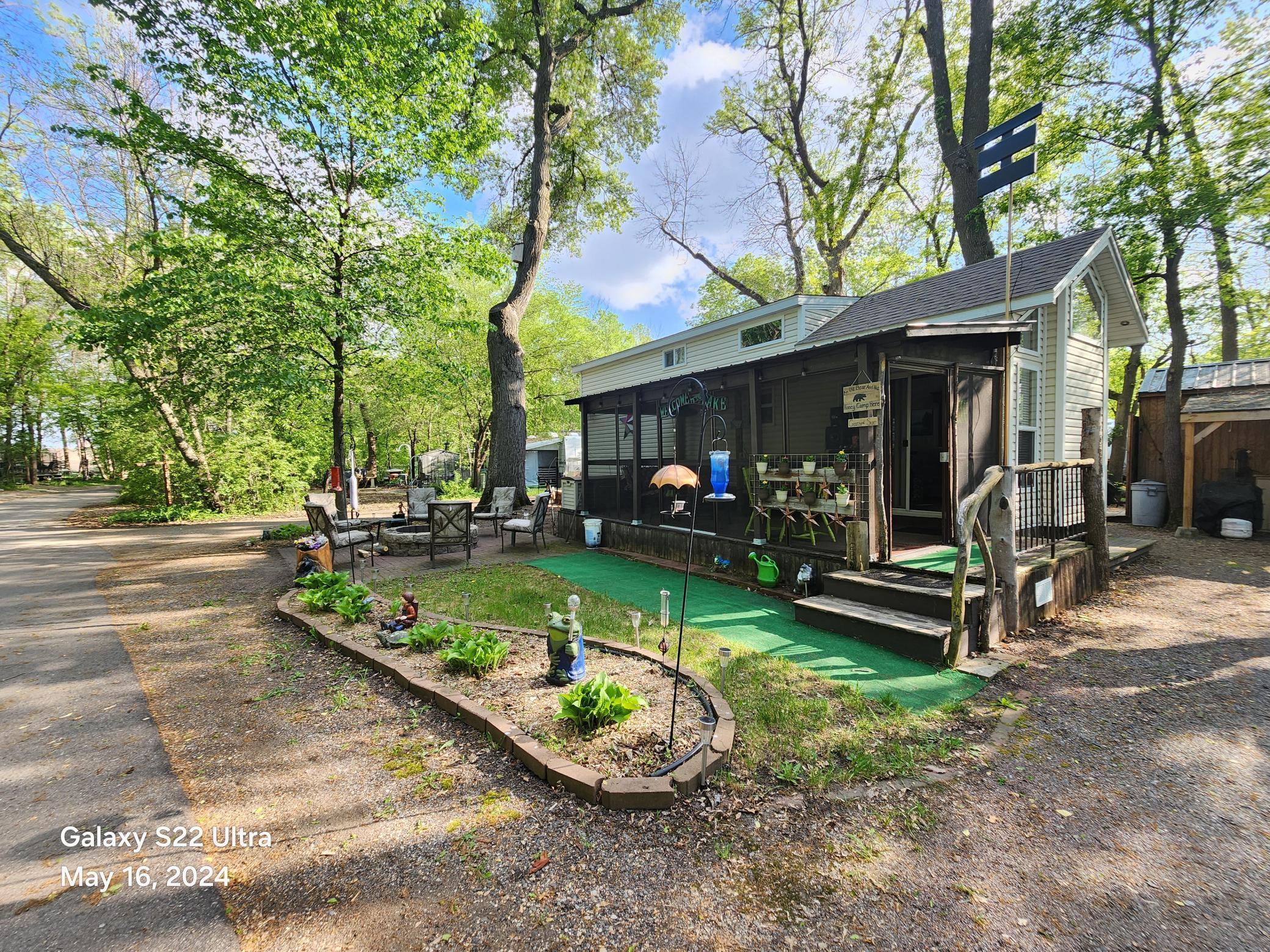 Front of Unit 428 at Cokato Lake RV Resort - a 2017 Park Model with Loft, sunken bedroom and living room. Screen porch with metal roof. Shed, large back yard for parking and playing games, etc. Cokato Lake RV Resort - Best RV Resort in Minnesota!