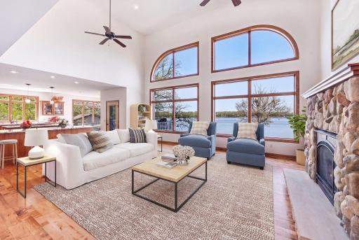 Main level living room with souring ceilings and beautiful lake views. Virtually staged.