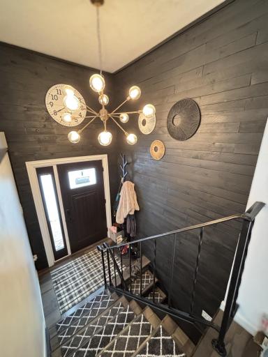 Main floor entrance with accent wall and new lighting fixture