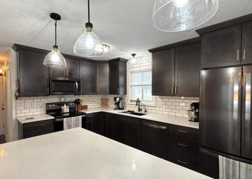 Kitchen has new lighting fixtures, tiled back splash, soft closure cabinets.