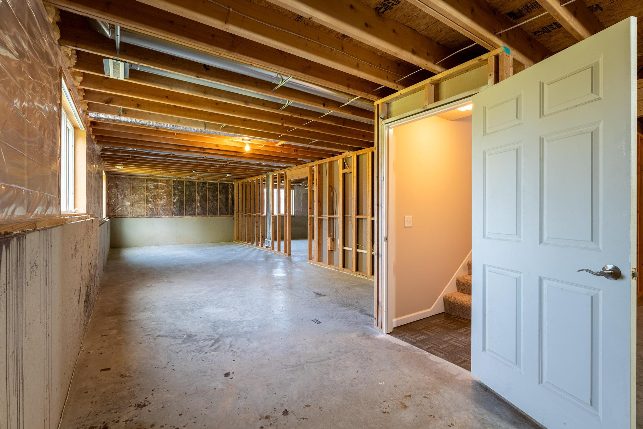 The remainder of the space is unfinished, offering excellent potential to create an additional bedroom, family room, or flexible living area tailored to your needs.
