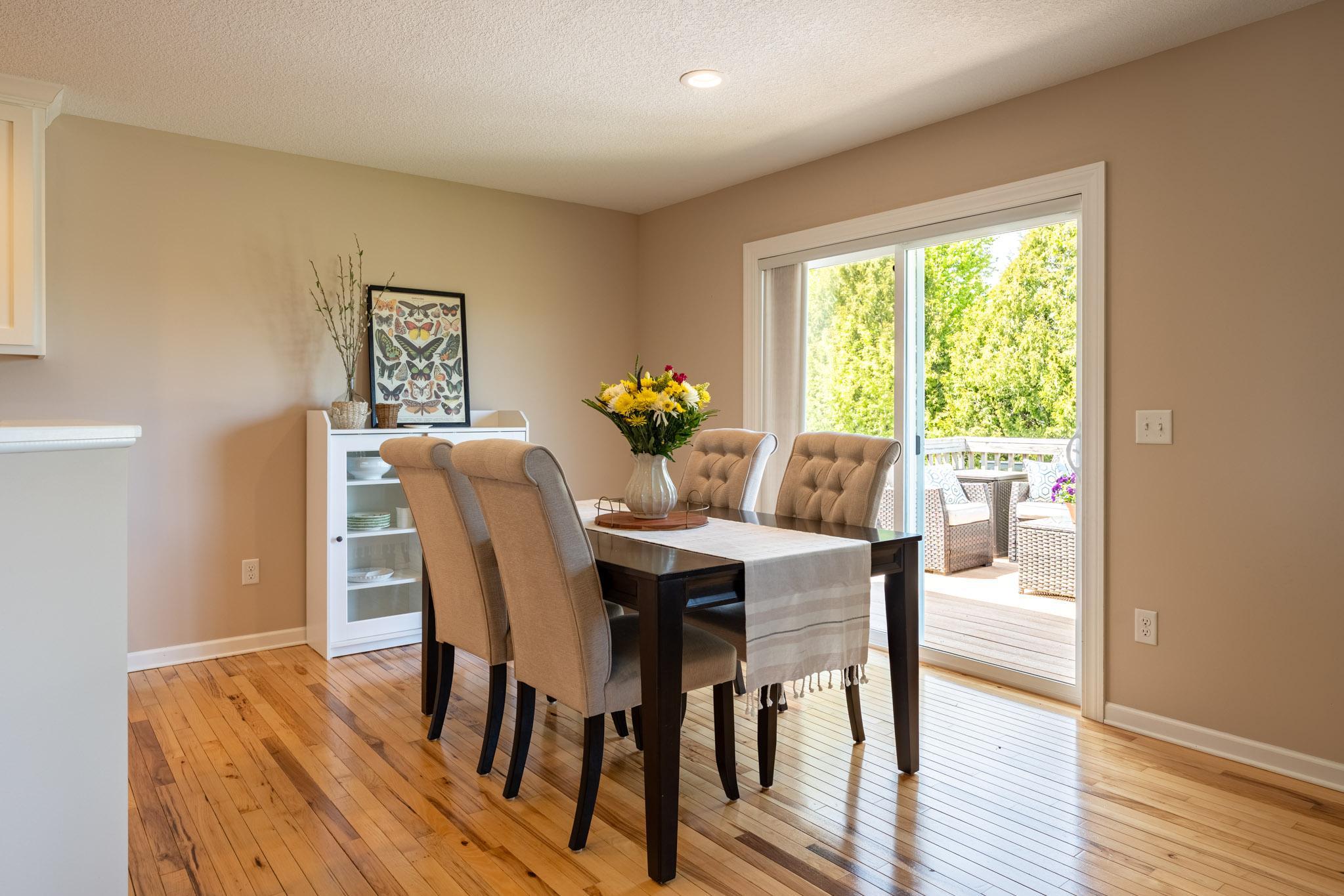 The dining area offers easy access to a large back deck through sliding glass doors, perfect for indoor-outdoor entertaining.