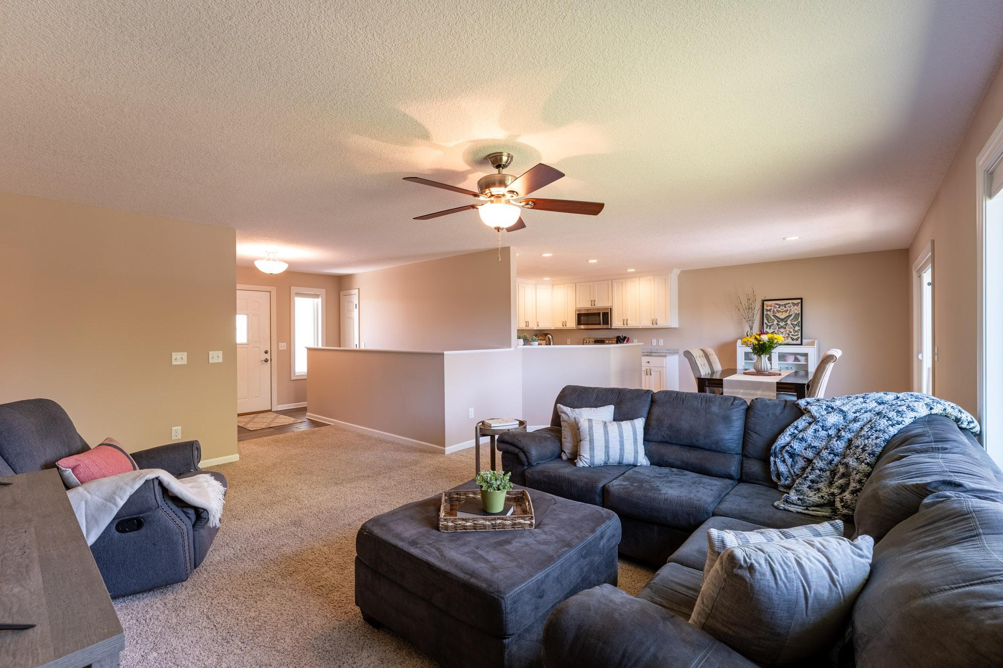 Living room open to the dining area and kitchen. Whole interior professionally painted May 2026.