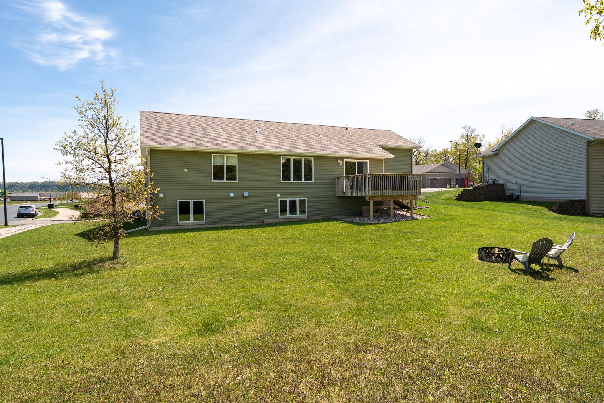Large back yard with firepit and garden shed.