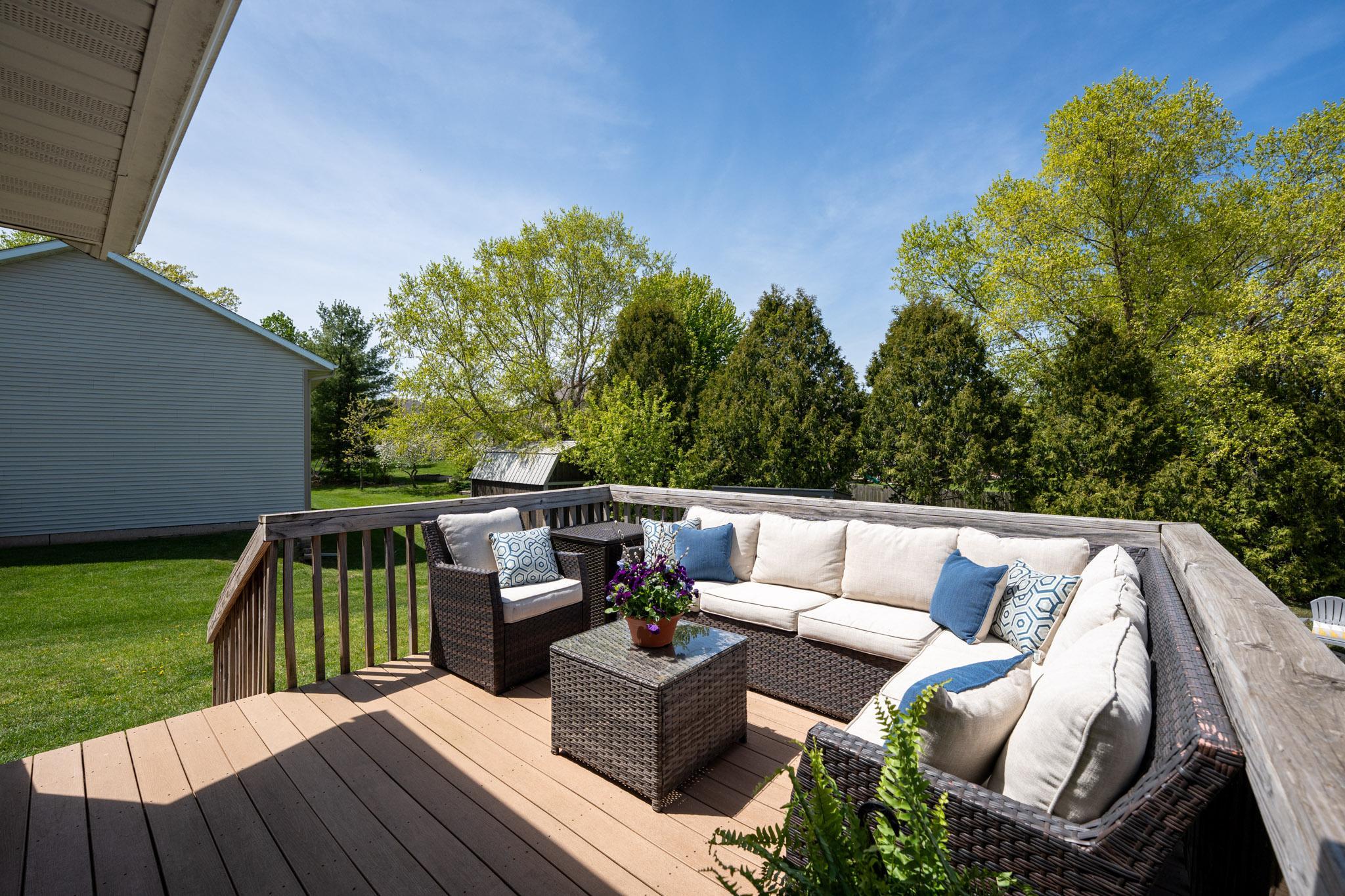 The deck, with maintainence free decking, has stairs leading down to the backyard.