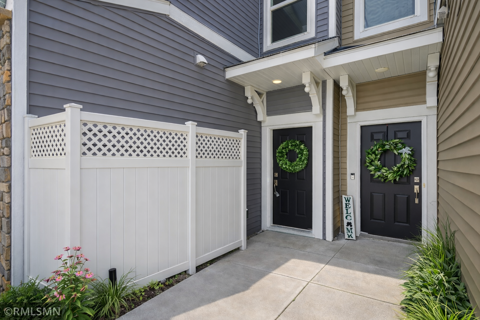 Door on the left virtually staged with privacy screening of the utilities
