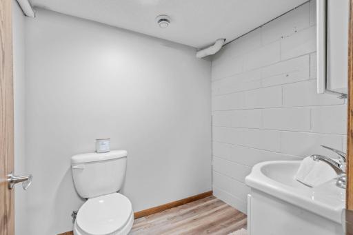 Convenient basement 1/2 bathroom with new floor and fixtures.