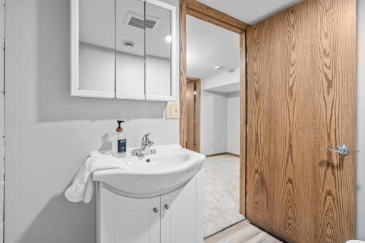 Convenient basement 1/2 bathroom with new floor and fixtures.