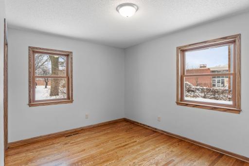Primary bedroom. 3 bedrooms ont he main level. Abundance of windows bring in a ton of natural light. Neutral paint and gorgeous hardwood flooring.