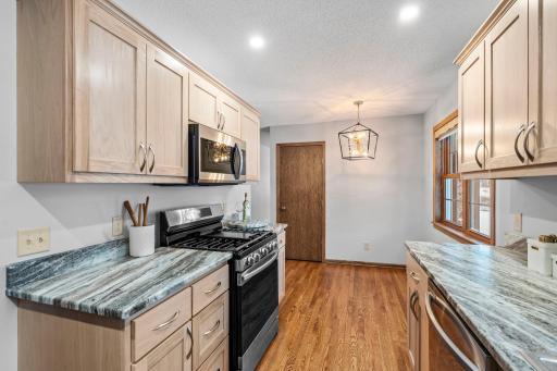 Informal dining nook with elegant lighting. Double closet spaces in kitchen and dining area.