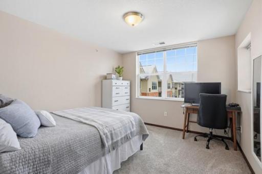 A bright and versatile second bedroom, perfect for guests, a home office, or a cozy personal space.