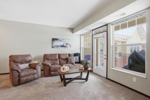 Bright living room with a sliding door that opens to the deck, bringing in natural light and easy indoor-outdoor living.