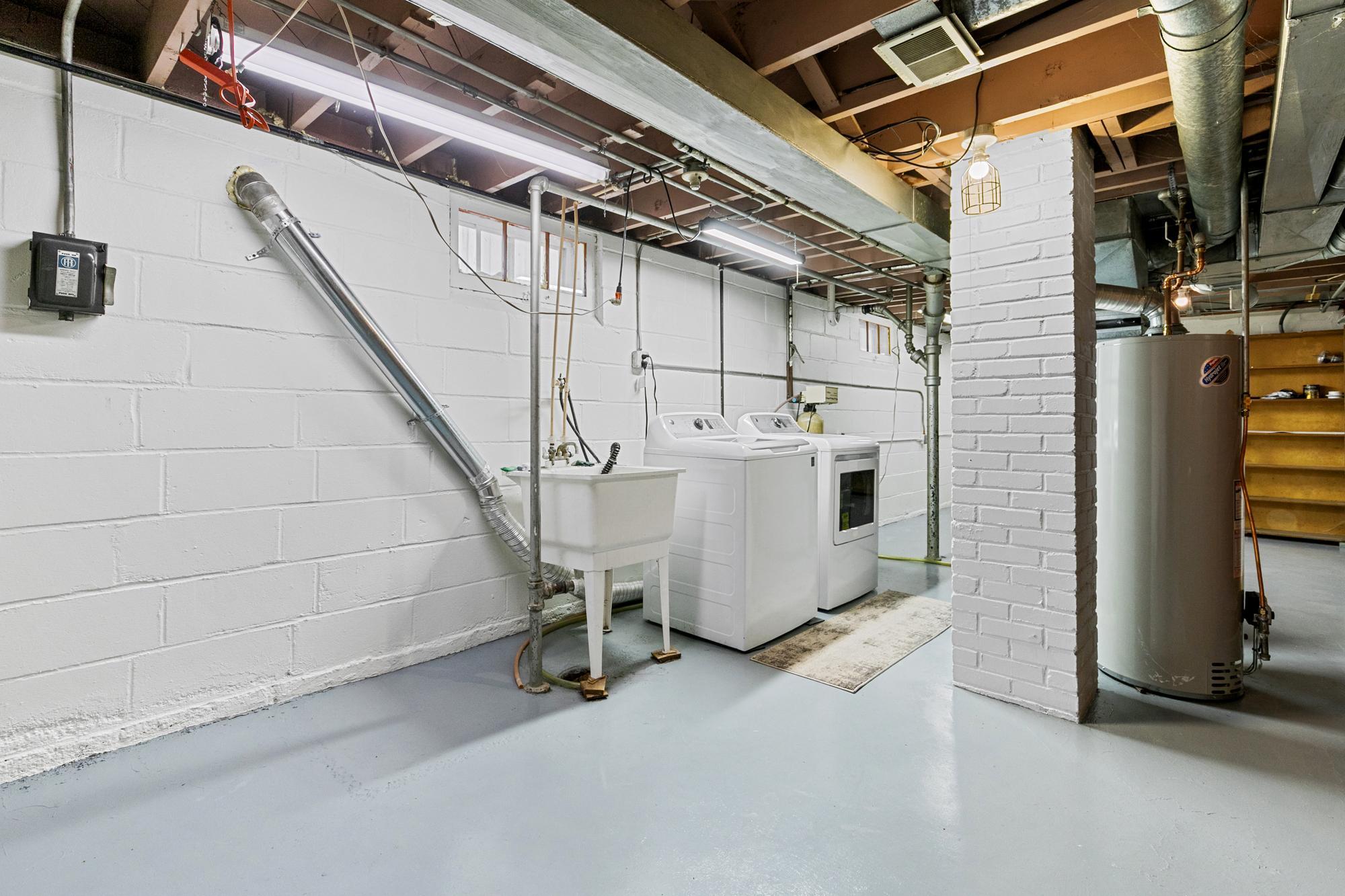 This side of the basement has fresh paint on both the walls and floor.